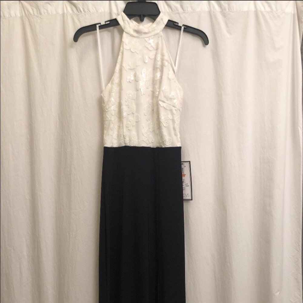 Black and a White Gown with Tags Attached